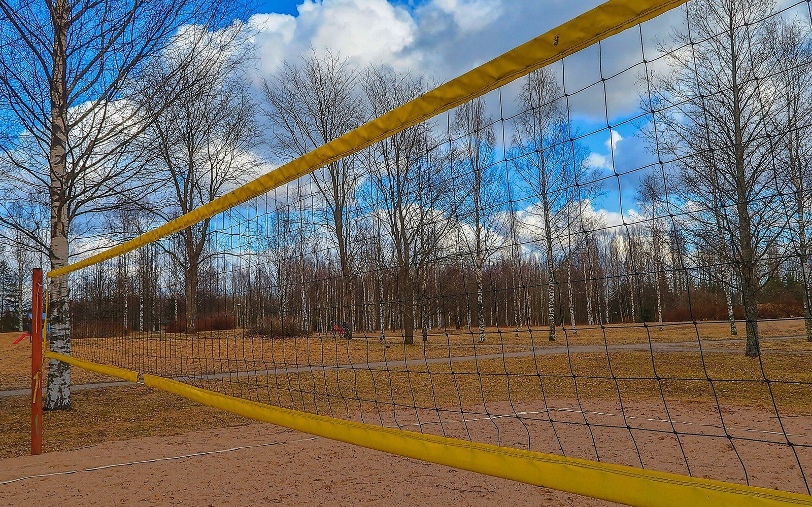 A net, antenna and post against sports-hall lighting, close