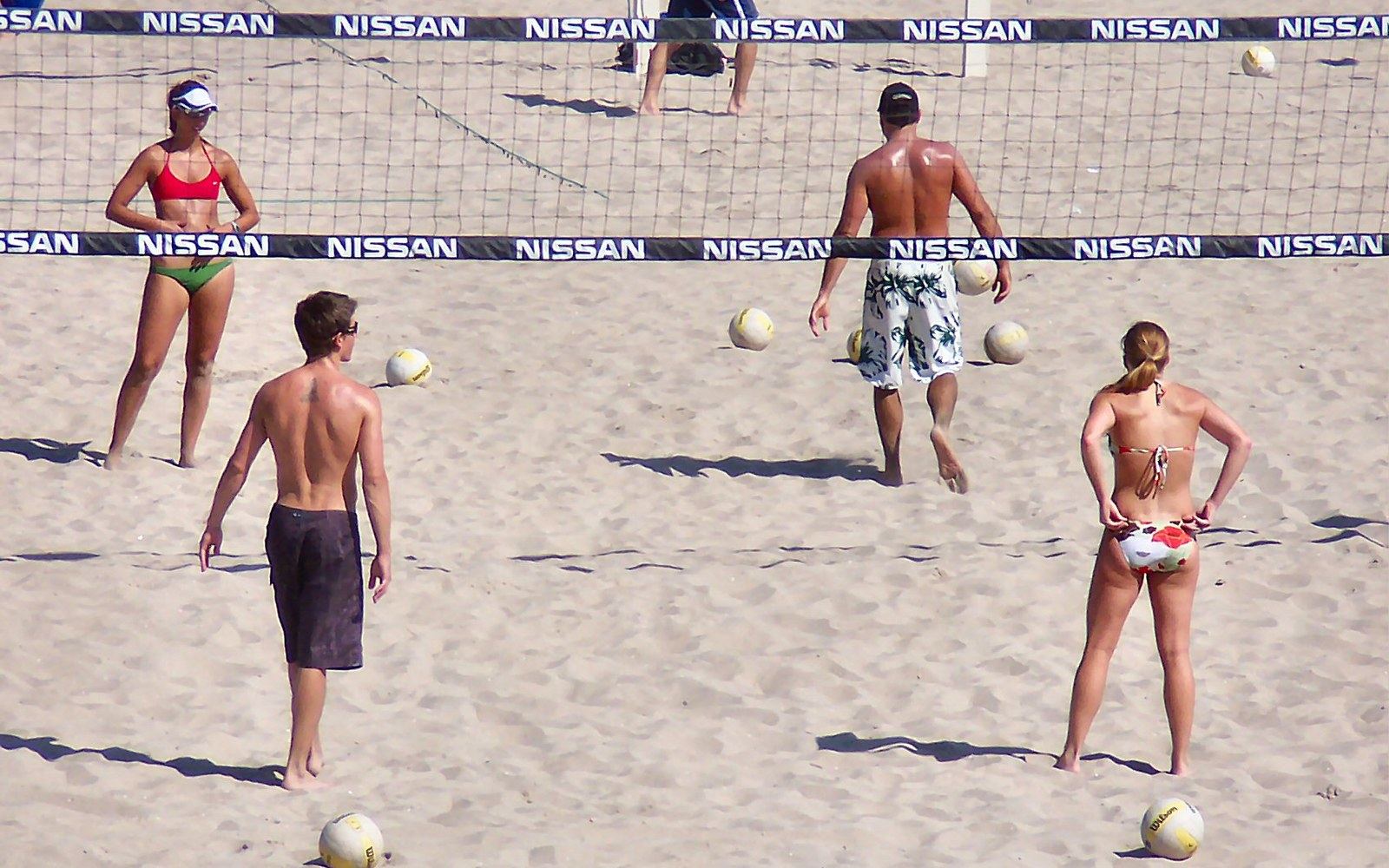 A beach volleyball court at low sun with the sand freshly raked